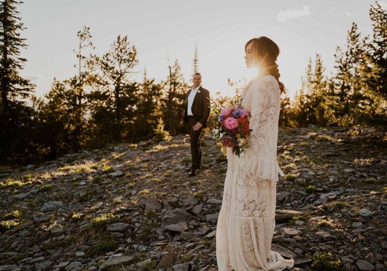 mountain elopement couples standing in wedding attire and florals